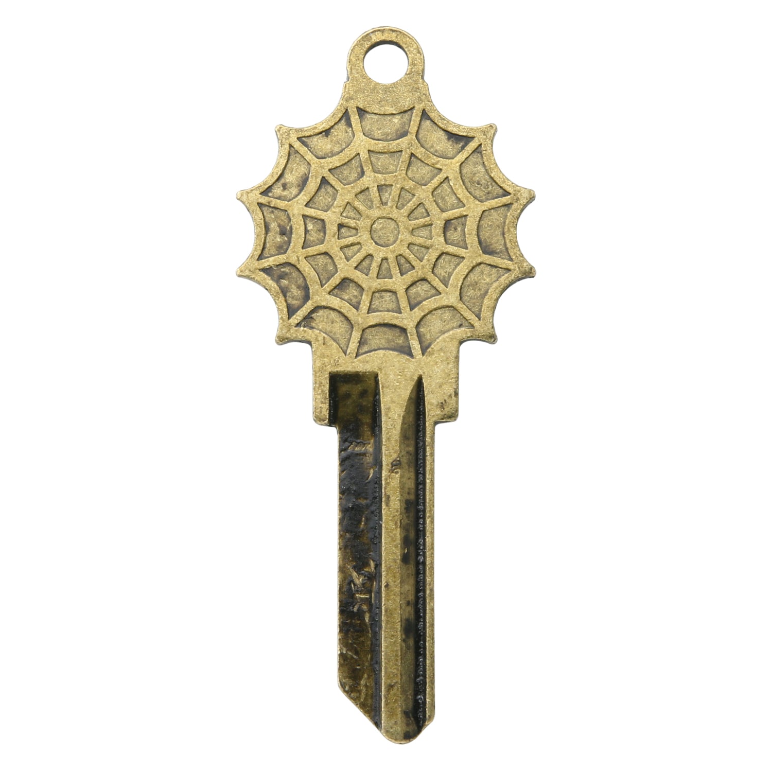 Brass key on white background with spiderweb design.