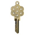Brass key on white background with geometric design.