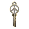 Brass key on white background with peace sign design.