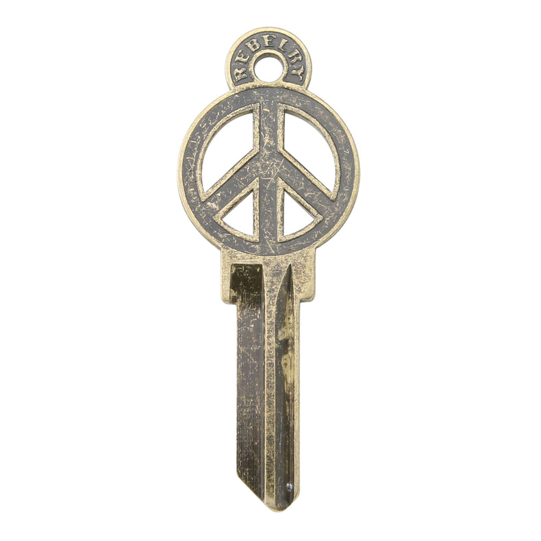 Brass key on white background with peace sign design.